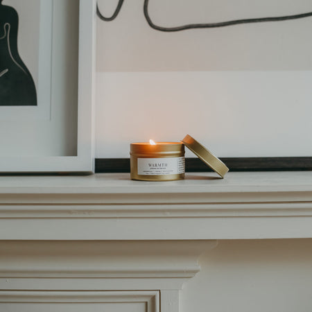 Gold soy candle on mantle