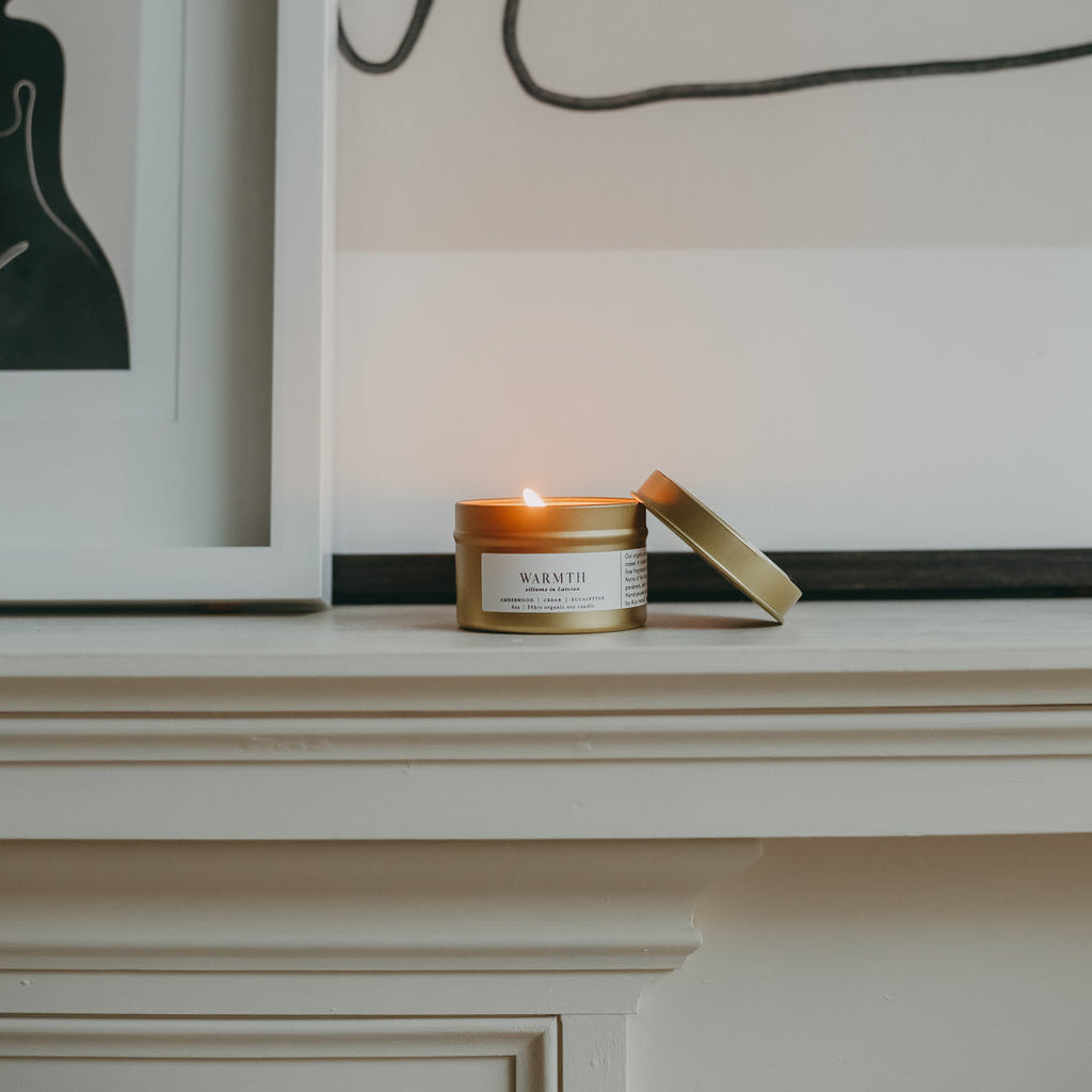 Gold soy candle on mantle