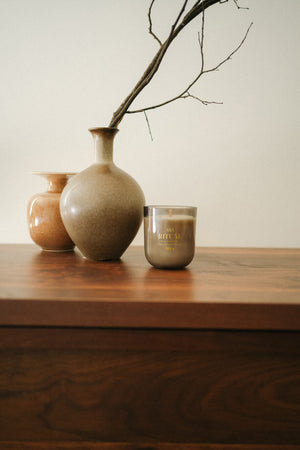 RITUAL scented candle styled in a cozy interior with warm natural tones and seasonal decor